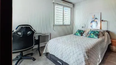 a bedroom with a bed and a desk and a chair at Nice barelli in Nice