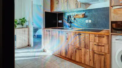 a kitchen with wooden cabinets and a sink at Nice barelli in Nice