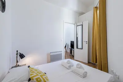 a bedroom with a bed with two towels on it at 33 GAMBETTA - Appartement 2 pieces Mezzanine in Nice