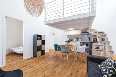 a kitchen and living room with a table and chairs at 33 GAMBETTA - Appartement 2 pieces Mezzanine in Nice