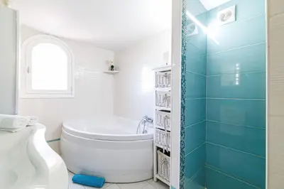 a white bathroom with a tub and a toilet at VILLA LAVANDINE - Maison Provencale avec Piscine - Magnifique vue in Aspremont