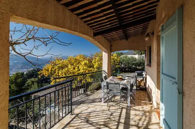a patio with a table and chairs on a balcony at VILLA LAVANDINE - Maison Provencale avec Piscine - Magnifique vue in Aspremont