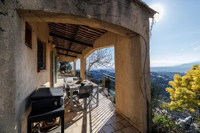an outdoor patio with a grill and a table on a balcony at VILLA LAVANDINE - Maison Provencale avec Piscine - Magnifique vue in Aspremont