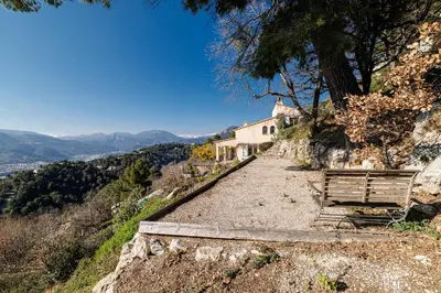 a house on the side of a hill with a bench at VILLA LAVANDINE - Maison Provencale avec Piscine - Magnifique vue in Aspremont