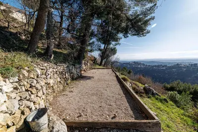 a path on a hill with a stone wall at VILLA LAVANDINE - Maison Provencale avec Piscine - Magnifique vue in Aspremont