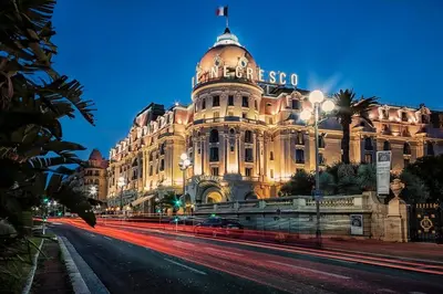 a large building on a city street at night at Cozy Apartment in Old Town Nice in Nice
