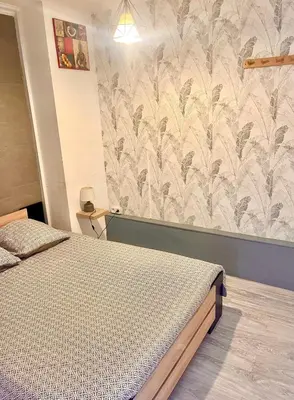 a bedroom with a bed and a wall mural at Fully-equipped 2-bedroom apartment in Nice