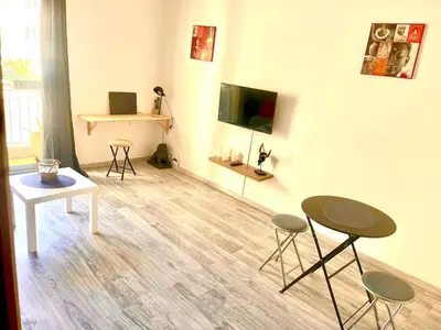 a living room with two tables and two stools at Fully-equipped 2-bedroom apartment in Nice