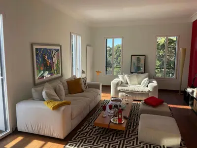 a living room with two couches and a coffee table at Sea View Villa In The Hills Of Nice in Nice