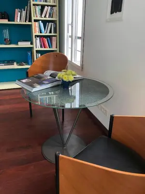 a glass table with a book and flowers on it at Sea View Villa In The Hills Of Nice in Nice