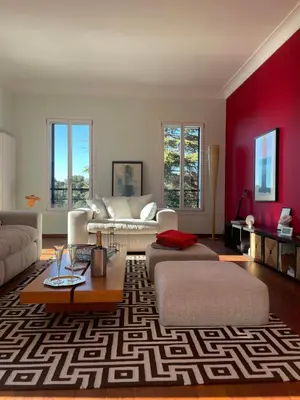 a living room with two couches and a red wall at Sea View Villa In The Hills Of Nice in Nice