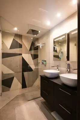 a bathroom with two sinks and a glass shower at Sea View Villa In The Hills Of Nice in Nice
