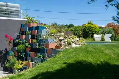 a garden with cacti and plants in pots at Sea View Villa In The Hills Of Nice in Nice