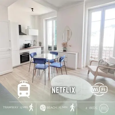 a kitchen with a table and chairs in a room at RF113 - 3P Appartement Cosy et Lumineux in Nice