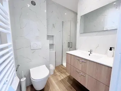 a white bathroom with a toilet and a sink at RF113 - 3P Appartement Cosy et Lumineux in Nice