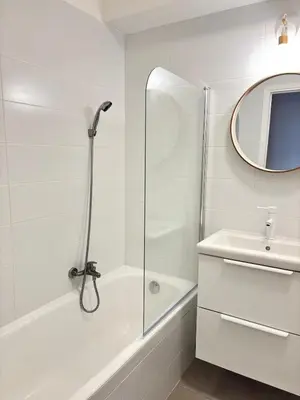 a white bathroom with a shower and a sink at Sea View Apartment 50 m to Beach FREE Parking in Cagnes-sur-Mer