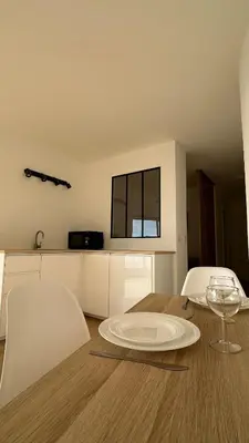 a dining room table with a plate on top of it at Sea View Apartment 50 m to Beach FREE Parking in Cagnes-sur-Mer