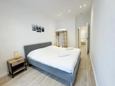 a bedroom with a white bed and a wooden floor at RF105 - Authentique 3P Nice centre in Nice