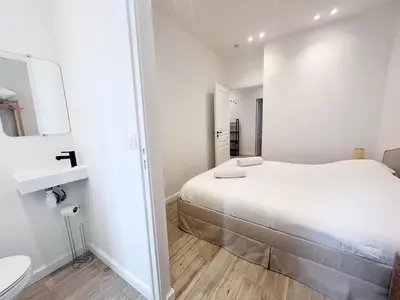 a white bedroom with a bed and a toilet at RF105 - Authentique 3P Nice centre in Nice