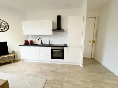 a kitchen with white cabinets and a black counter top at RF105 - Authentique 3P Nice centre in Nice