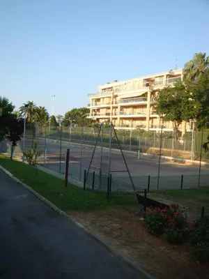 a swing set in a park next to a building at Appartement Résidence Héliotel in Saint-Laurent-du-Var