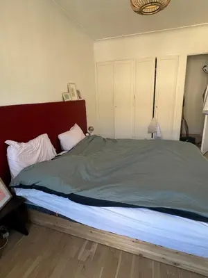 a bedroom with a large bed with a red headboard at Nice experience in Nice