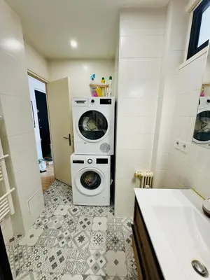 a bathroom with a washing machine and a washer and dryer at Nice experience in Nice