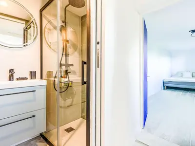 a bathroom with a shower with a glass door at Holiday Home Villa la Bergerie by Interhome in Nice