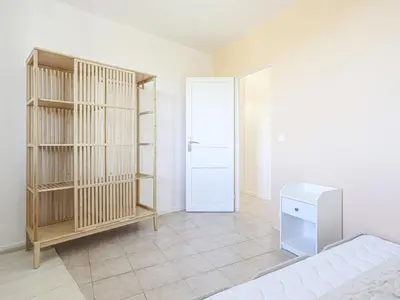 a bedroom with a bed and a closet and a door at Holiday Home Villa la Bergerie by Interhome in Nice