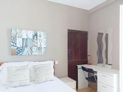 a bedroom with a bed and a desk with a chair at Apartment Le Mascoïnat by Interhome in Nice