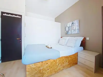 a bedroom with a large bed with a blue blanket at Apartment Le Mascoïnat by Interhome in Nice