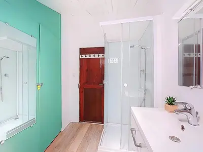 a bathroom with a shower and a sink and a mirror at Apartment Le Mascoïnat by Interhome in Nice