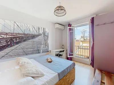 a bedroom with a bed and a large window at Apartment Le Mascoïnat by Interhome in Nice