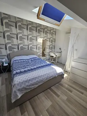 a bedroom with a bed and a tv on the wall at Appartement 2 pièces à 5 mn de la plage N3 in Saint-Laurent-du-Var