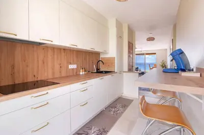 a kitchen with white cabinets and a counter top at Le rêve bleu in Nice
