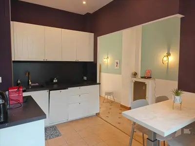 a kitchen with white cabinets and a table in it at Spacious NEW Apt near Promenade up to 6 with AC in Nice