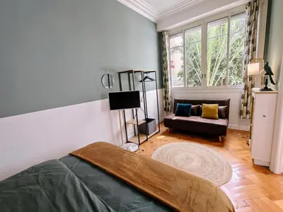 a bedroom with a bed and a couch at Spacious NEW Apt near Promenade up to 6 with AC in Nice