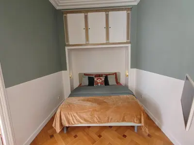 a small bedroom with a bed in the corner at Spacious NEW Apt near Promenade up to 6 with AC in Nice