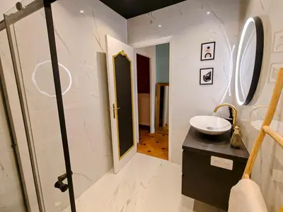 a bathroom with a sink and a mirror at Spacious NEW Apt near Promenade up to 6 with AC in Nice