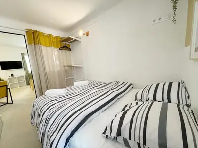a bedroom with two beds with striped sheets at RF107 - Moderne 3P Nice Port Place du Pin in Nice