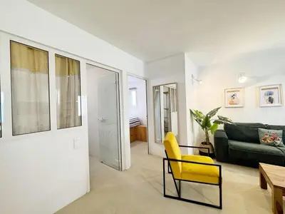 a living room with a yellow chair and a couch at RF107 - Moderne 3P Nice Port Place du Pin in Nice