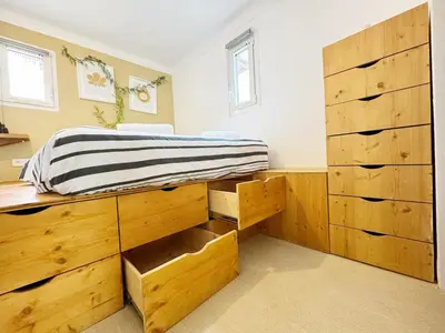 a bedroom with a bed with wooden drawers at RF107 - Moderne 3P Nice Port Place du Pin in Nice