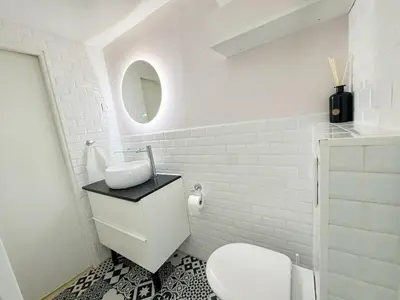 a white bathroom with a toilet and a mirror at RF107 - Moderne 3P Nice Port Place du Pin in Nice
