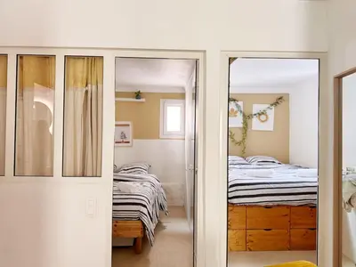a bedroom with a bed and a sliding glass door at RF107 - Moderne 3P Nice Port Place du Pin in Nice