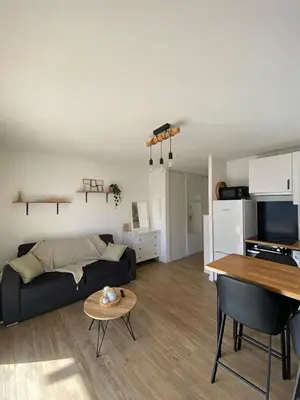 a living room with a couch and a table at Studio cosy proche de la mer in Nice