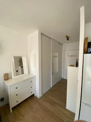 a white room with a dresser and a mirror at Studio cosy proche de la mer in Nice
