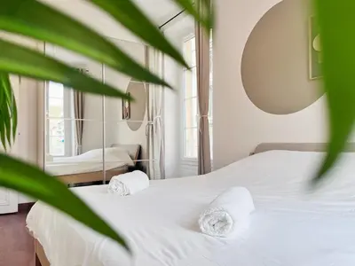a bedroom with a white bed with towels on it at RF109 - Spacieux 4P au cœur de Nice in Nice