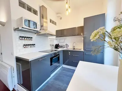 a kitchen with blue cabinets and white appliances at RF109 - Spacieux 4P au cœur de Nice in Nice