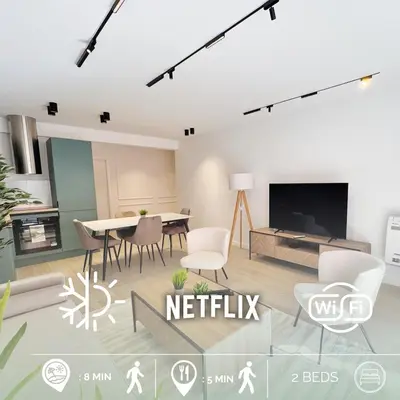a living room with a table and chairs and a tv at RF112 - T3 Lumineux à deux pas du port in Nice