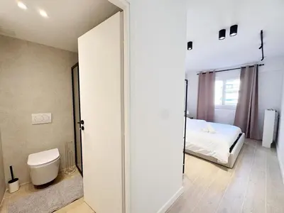 a white room with a bed and a toilet at RF112 - T3 Lumineux à deux pas du port in Nice